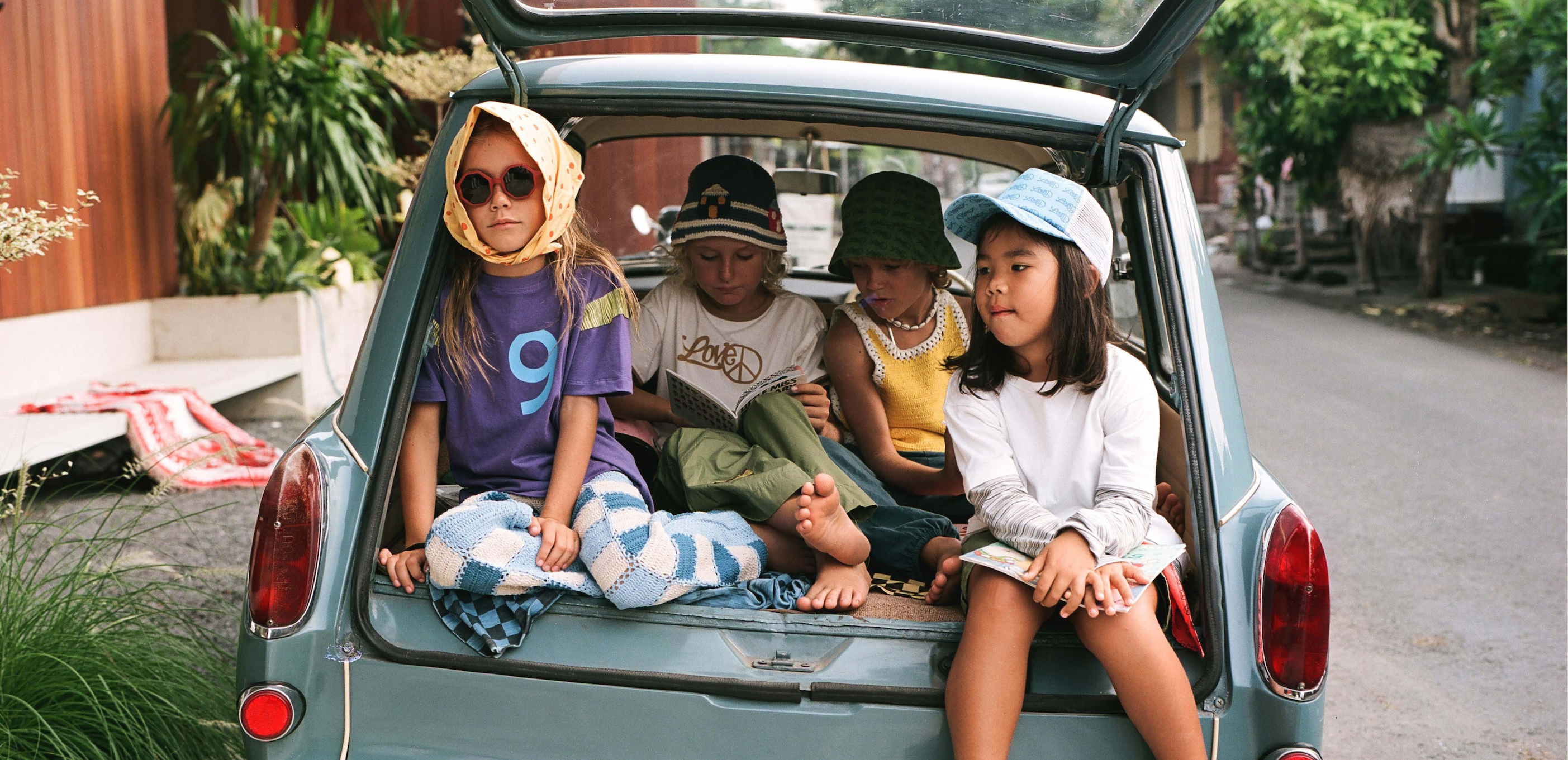 Child in bucket hat and oversized cotton tee